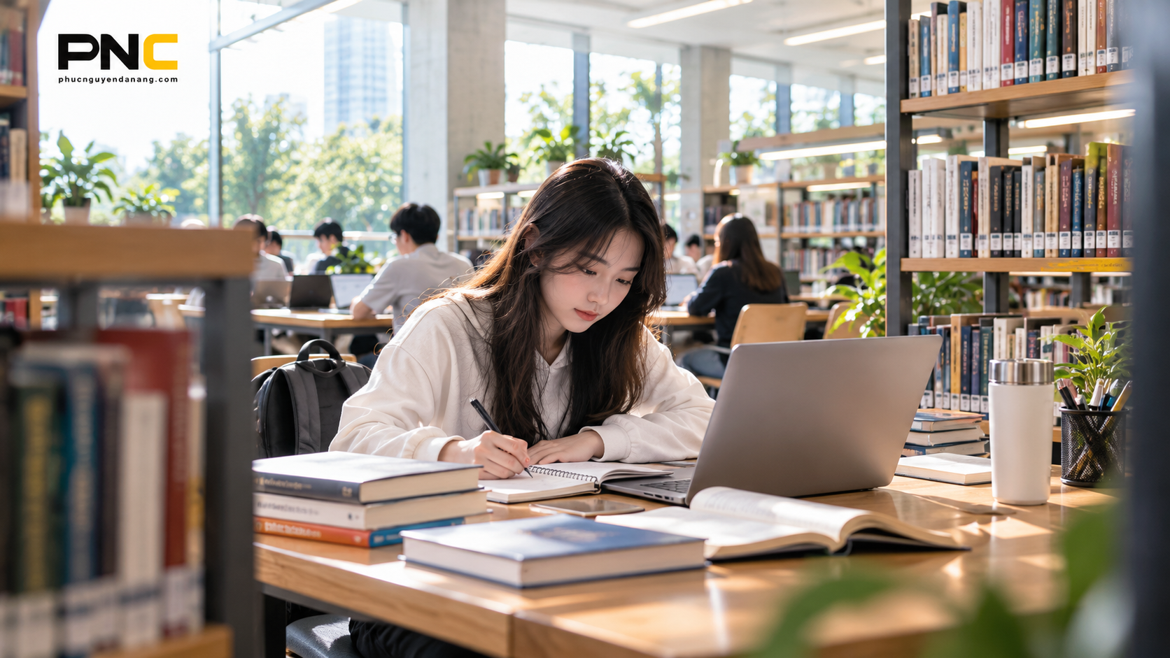 Sinh viên học tập với laptop gọn nhẹ tại thư viện đại học